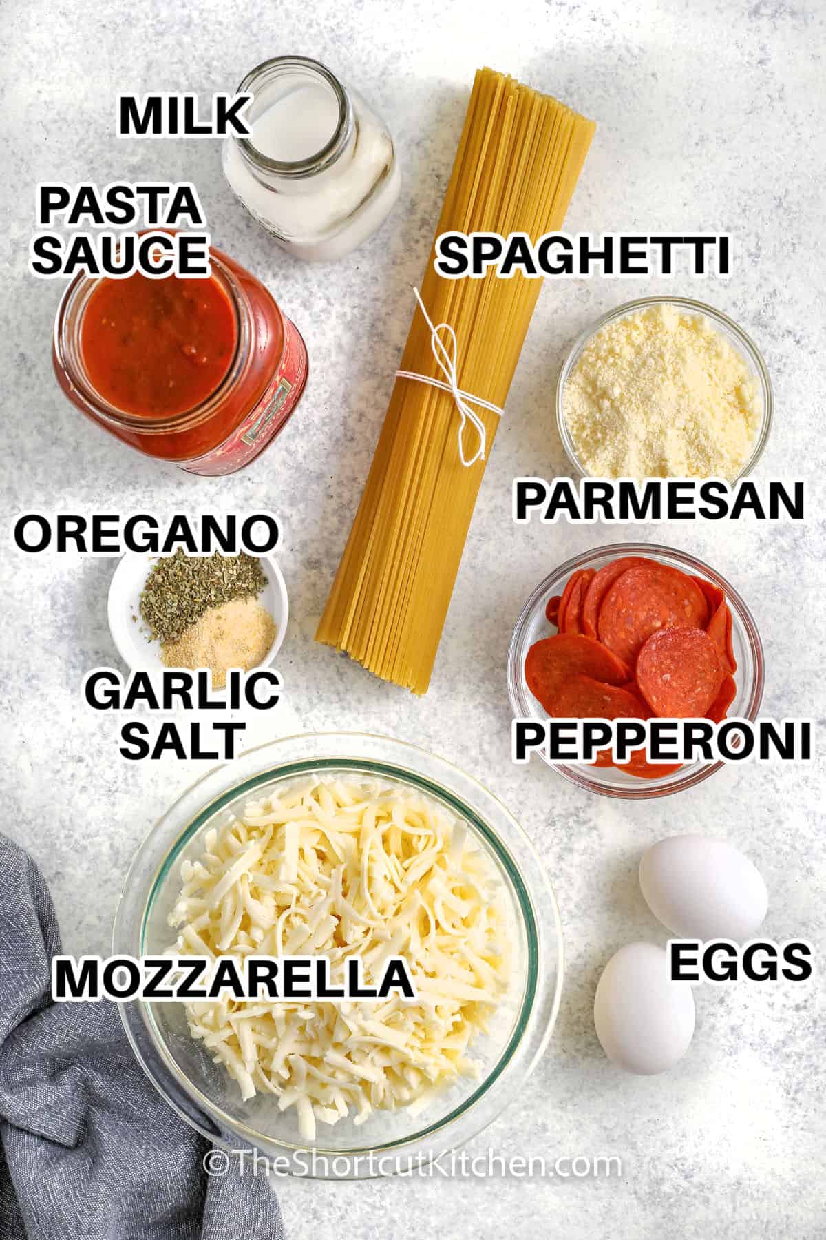 milk , pasta sauce , spaghetti , parmesan , pepperoni , oregano , garlic salt , eggs and mozzarella with labels to make Spaghetti Pizza