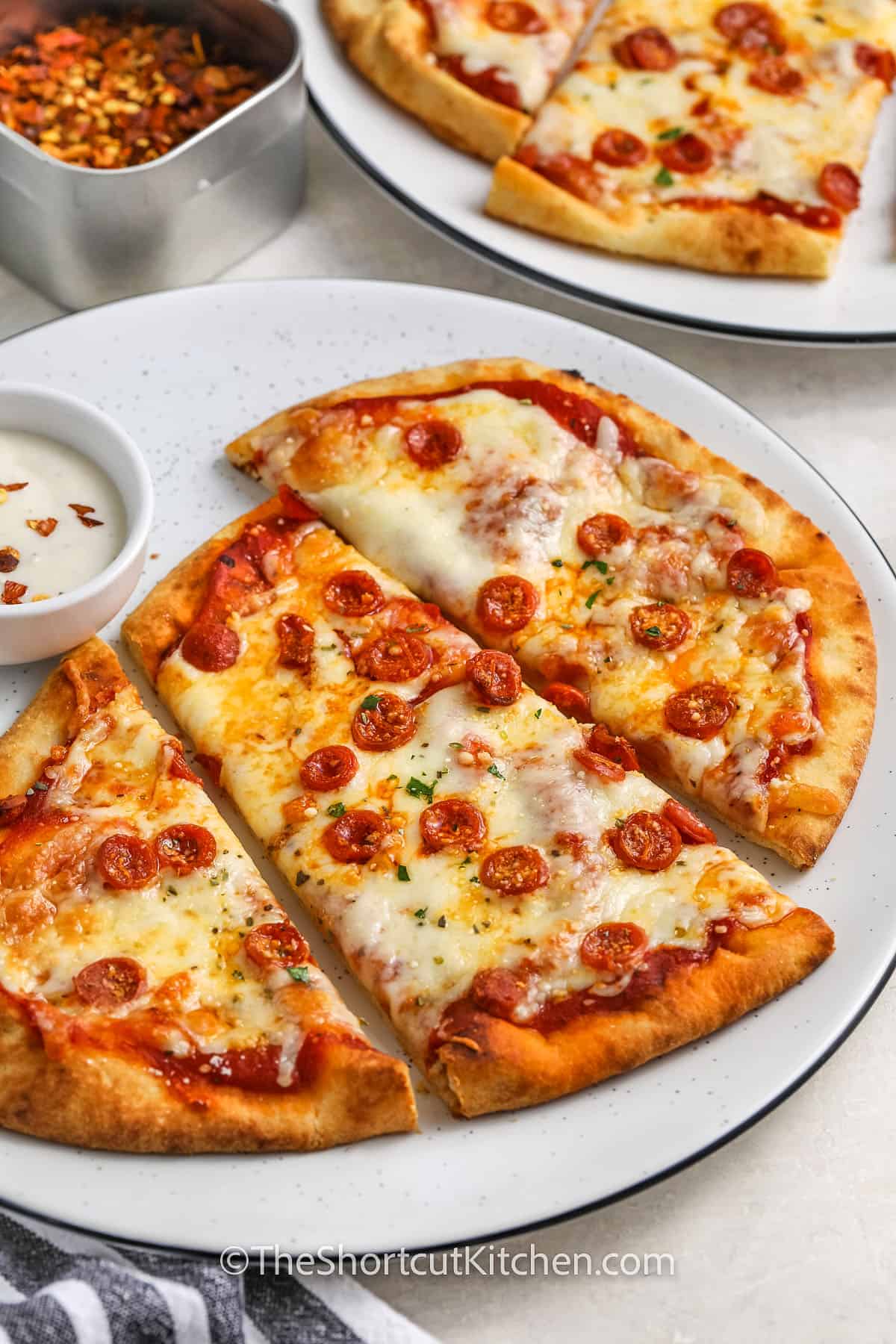 sliced naan pizza on a plate