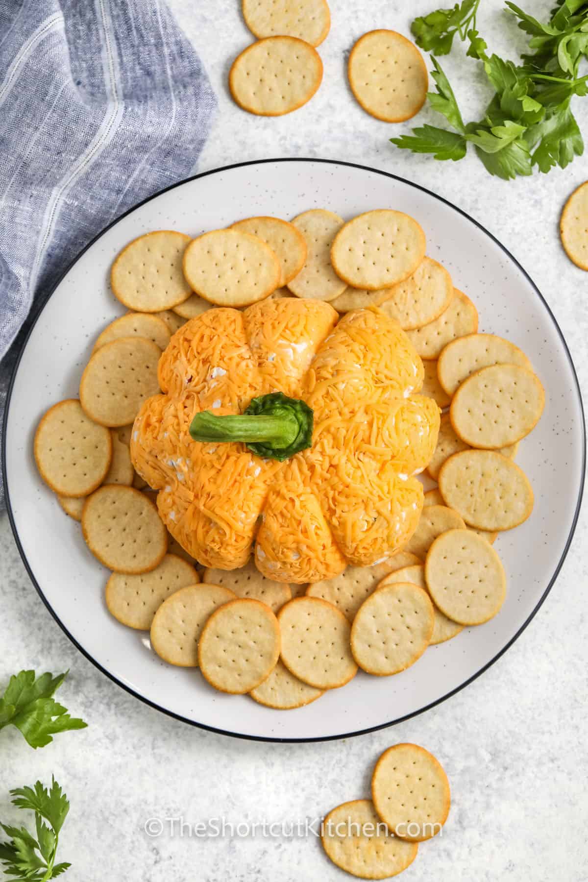 pumpkin cheese ball on a plate with crackers