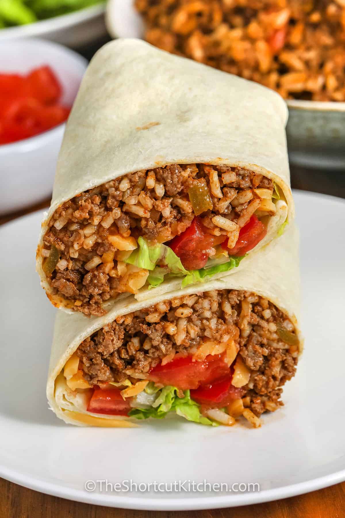 taco burritos assembled and stacked on a plate