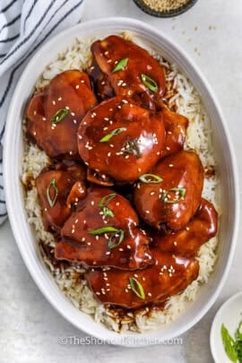 sweet and sticky Crockpot Honey Garlic Chicken on a bed of rice in a dish