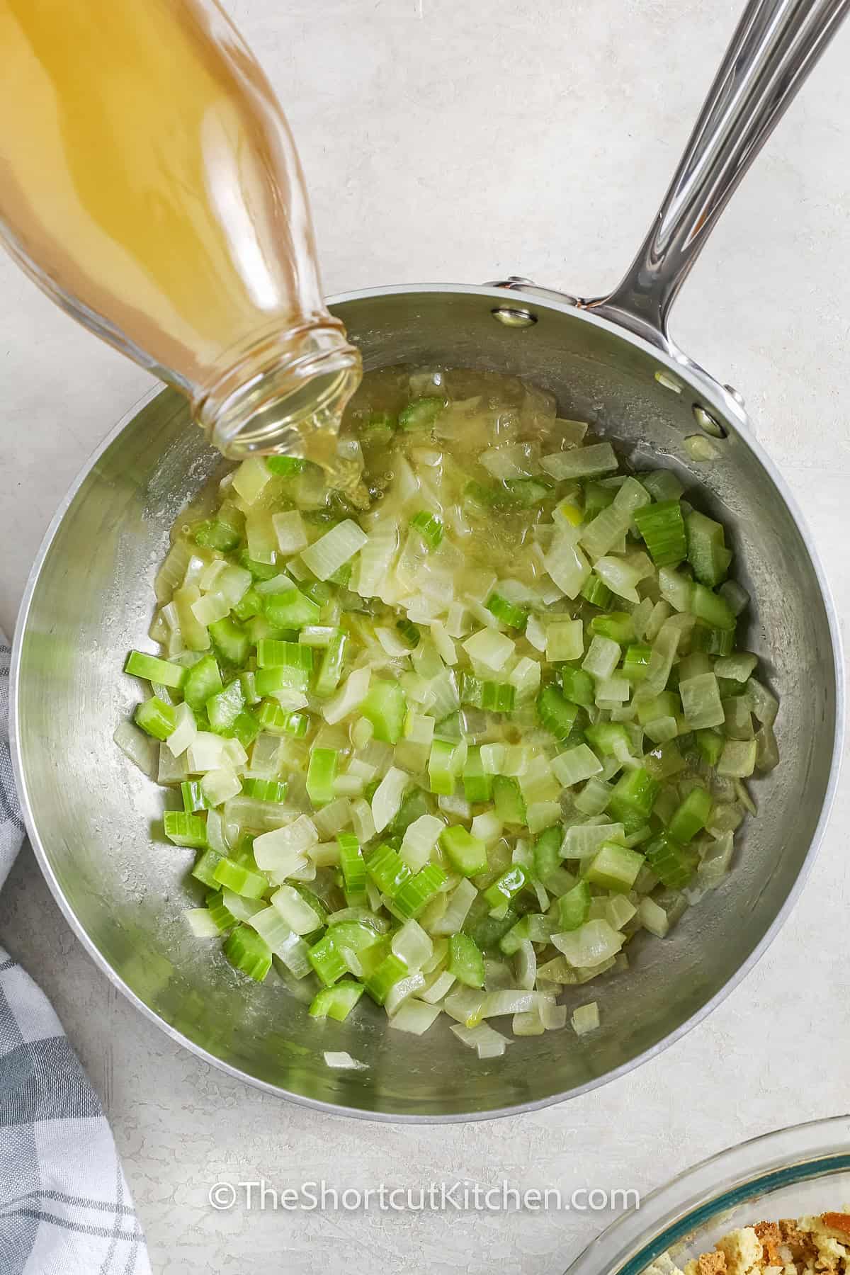 pouring broth into pan