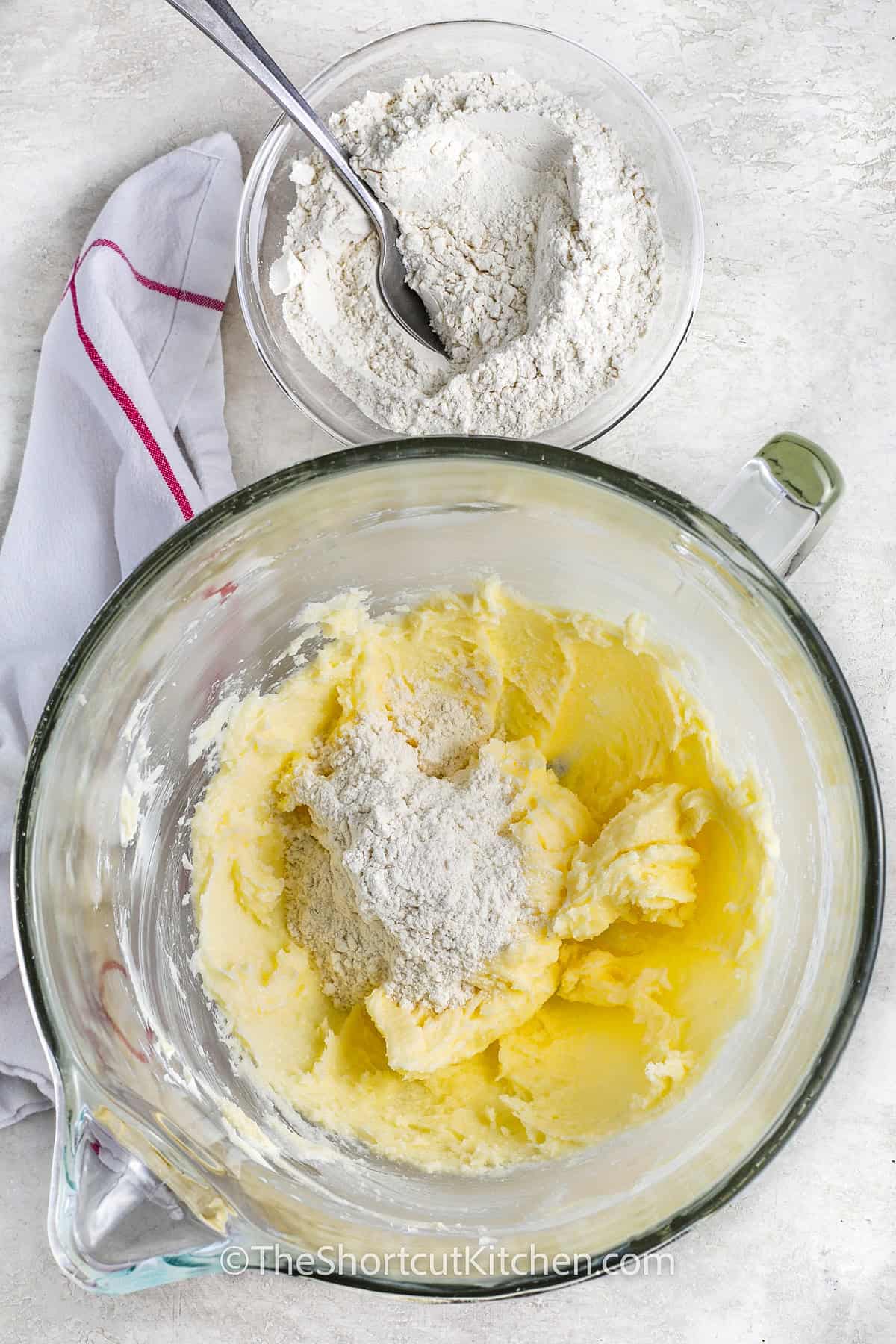 adding flour to butter and sugar mixture to make 3 Ingredient Sugar Cookie Recipe