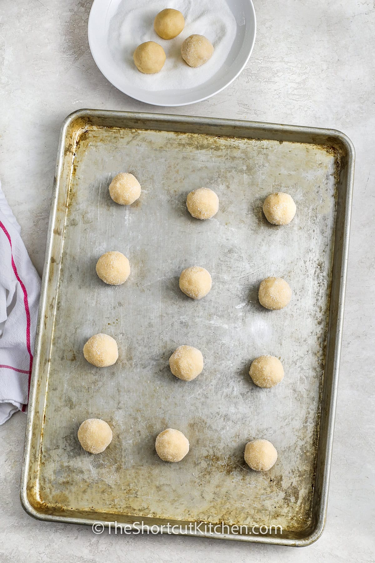 rolled ball of 3 Ingredient Sugar Cookie Recipe dough with sugar