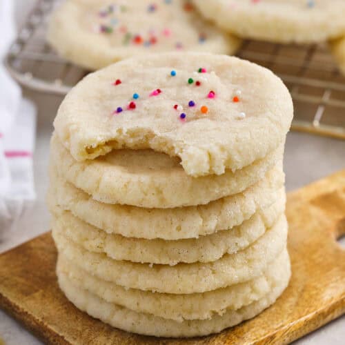 stack of 3 Ingredient Sugar Cookie Recipe with a bite taken out of one