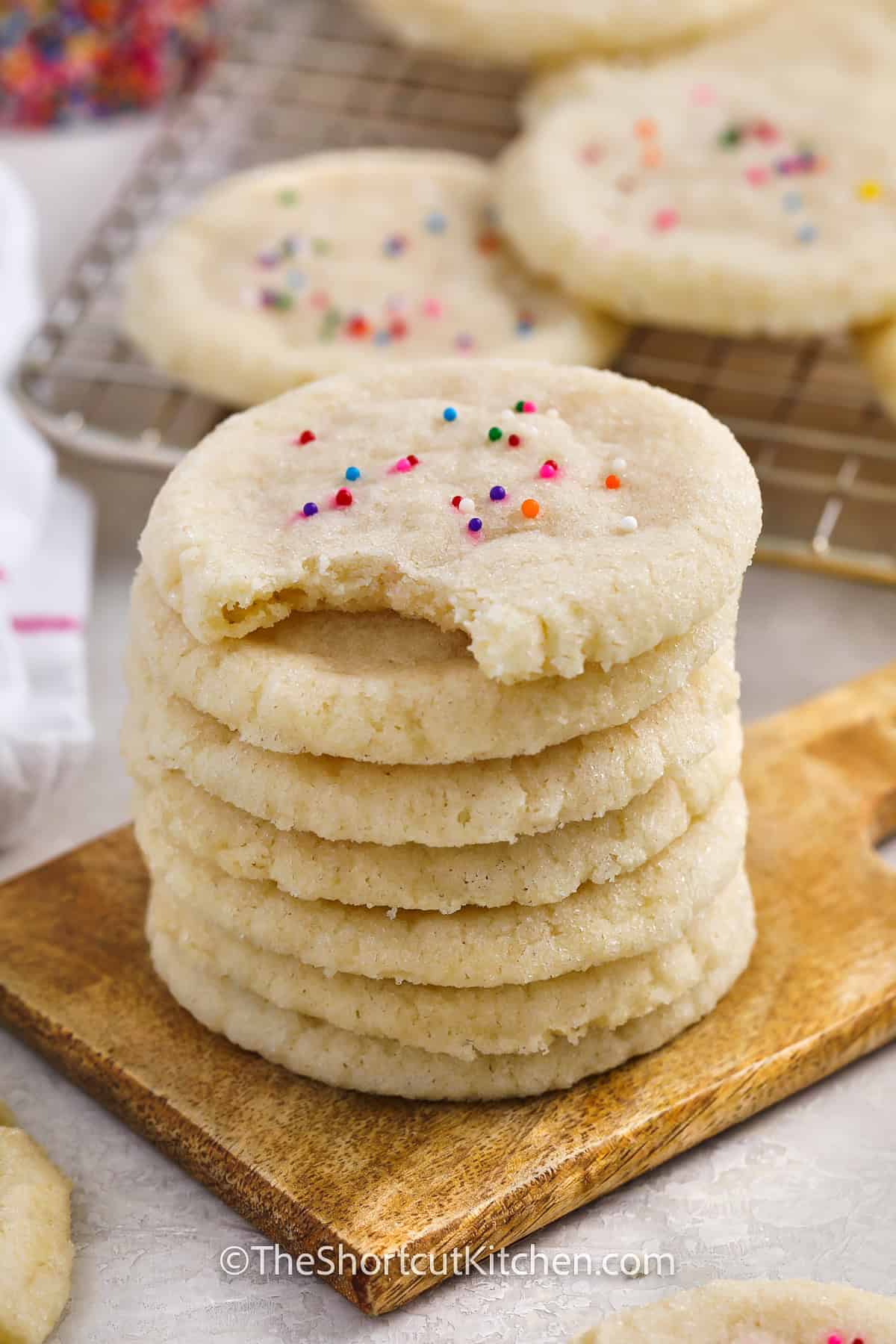 stack of 3 Ingredient Sugar Cookie Recipe with a bite taken out of one