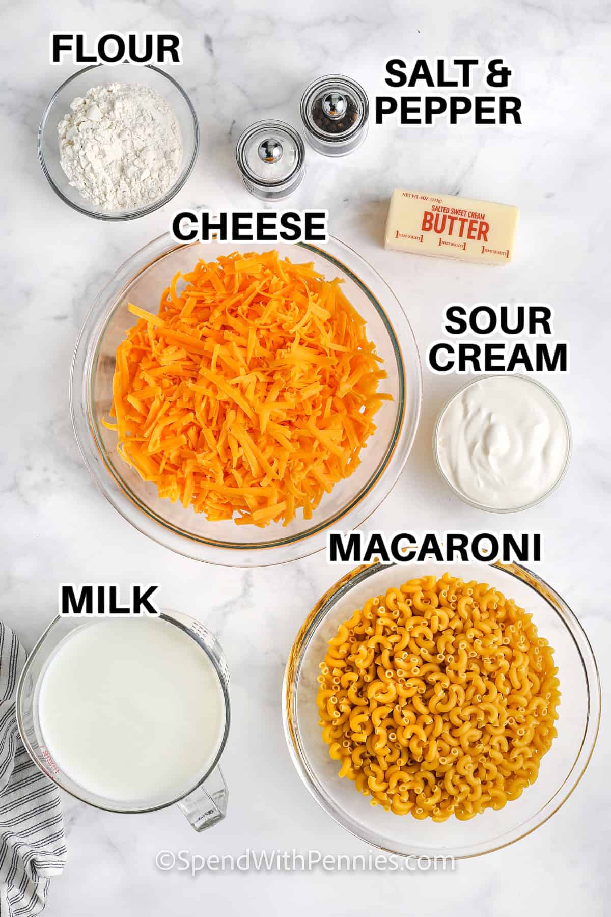 Ingredients to make Sour Cream Macaroni and Cheese including flour, salt, pepper, cheese, sour cream, macaroni, and milk