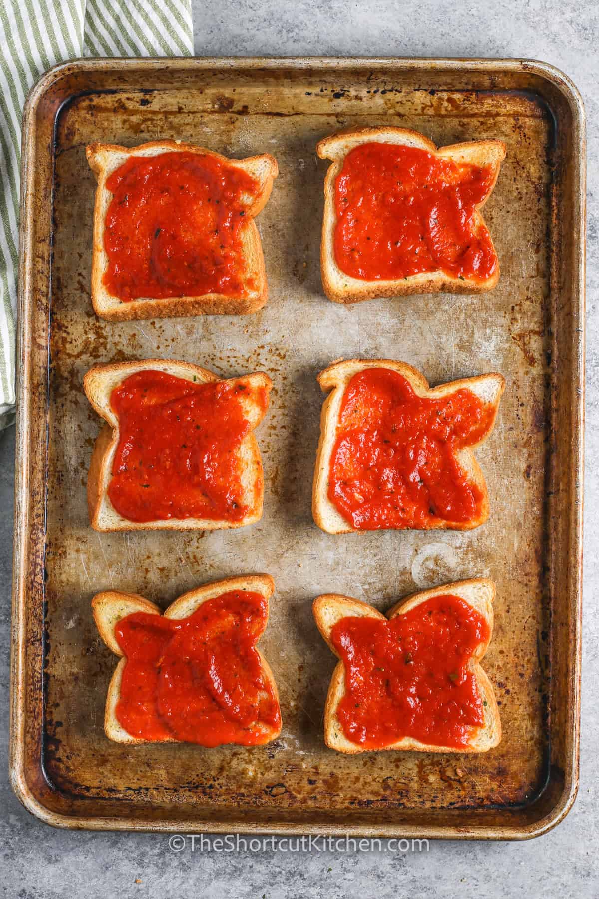 adding pizza sauce to texas toast to make Texas Toast Pizza