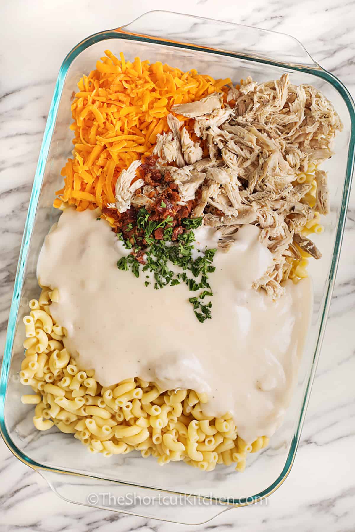 uncooked mac and cheese ingredients in a casserole dish