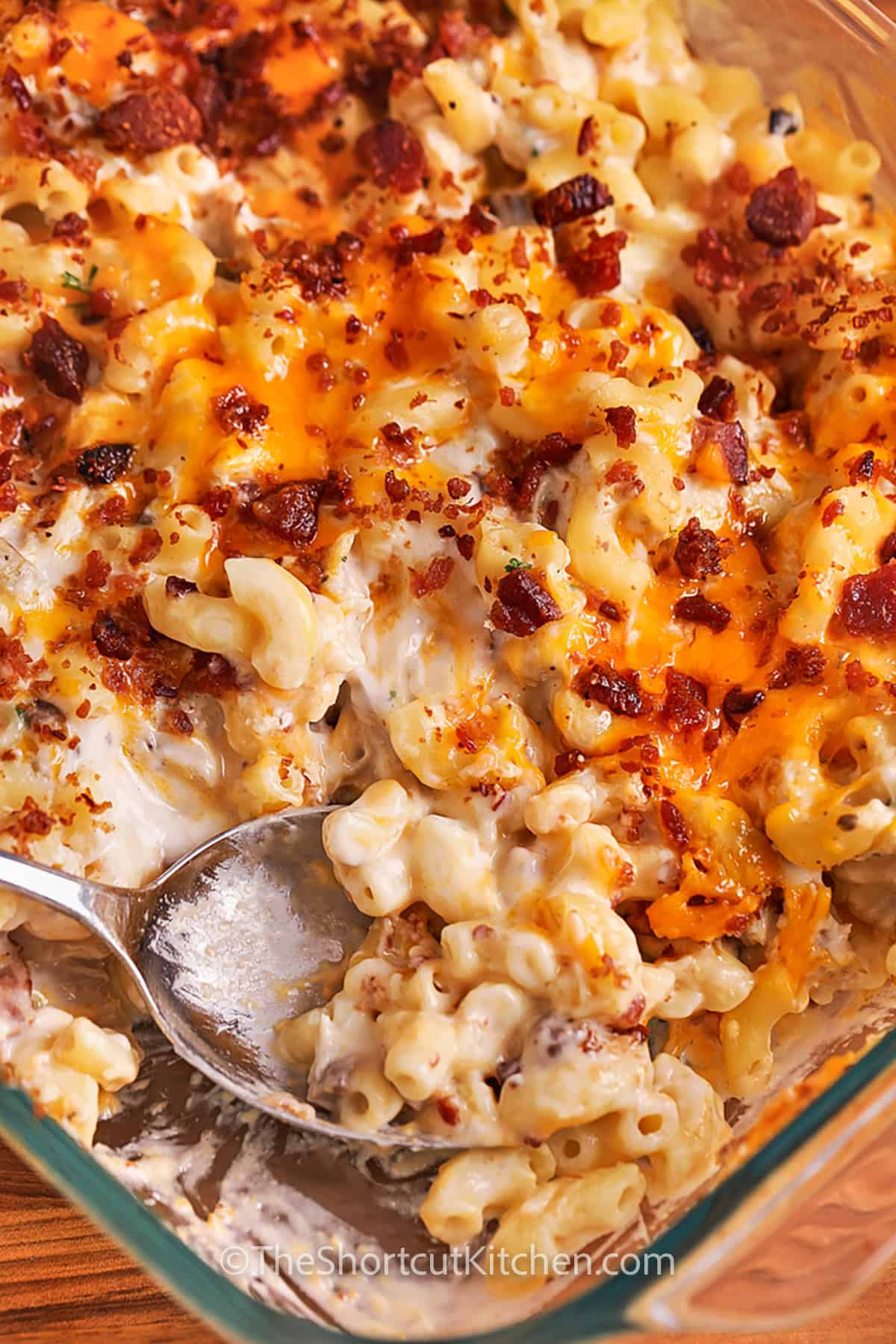 chicken mac and cheese in a casserole dish with a spoon