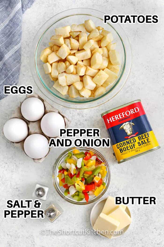 potatoes , eggs , butter , pepper and onion mix , corned beef , salt and pepper with labels to make Canned Corn Beef Hash