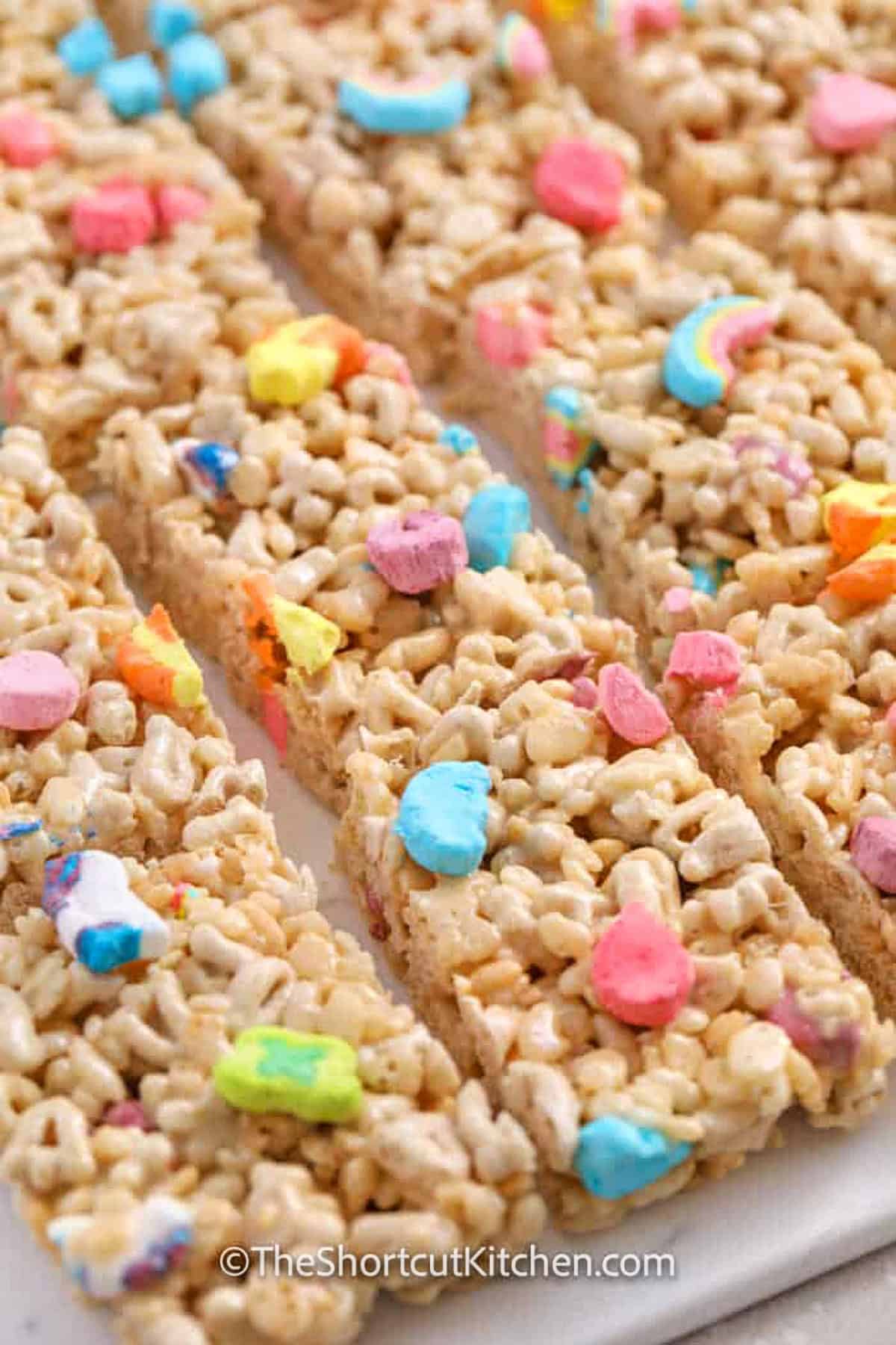 sliced Lucky Charms Rice Krispie Treats on a cutting board