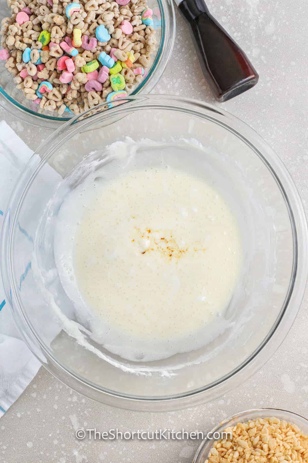adding vanilla to marshmallow mixture to make Lucky Charms Rice Krispie Treats