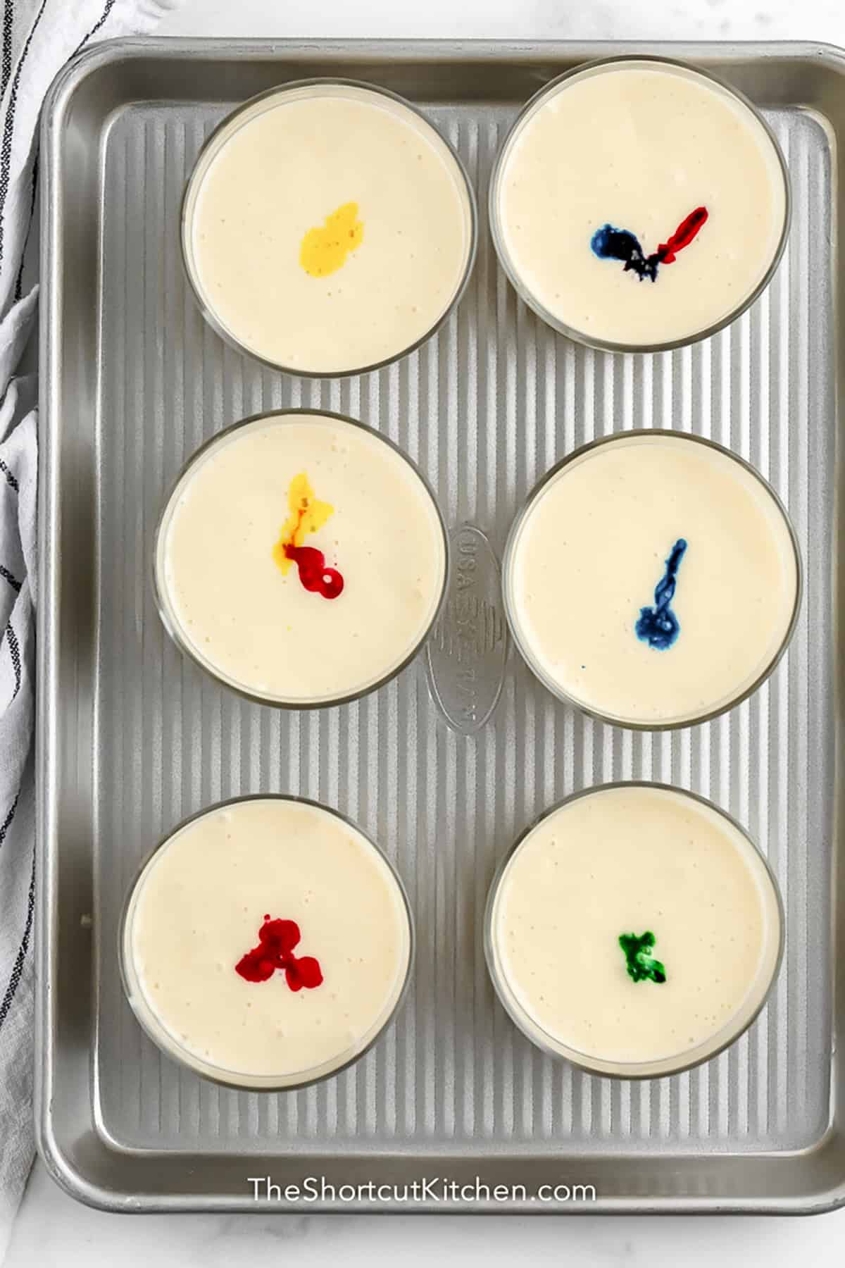 adding food coloring to Rainbow Cupcakes batter