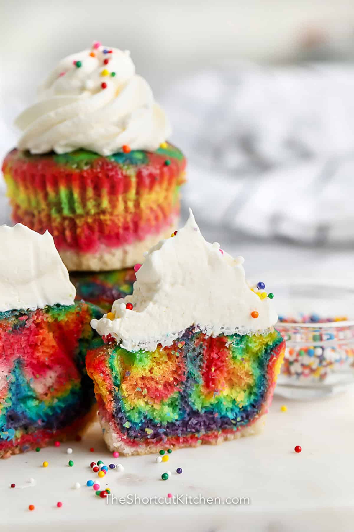 easy Rainbow Cupcakes with frosting and sprinkles