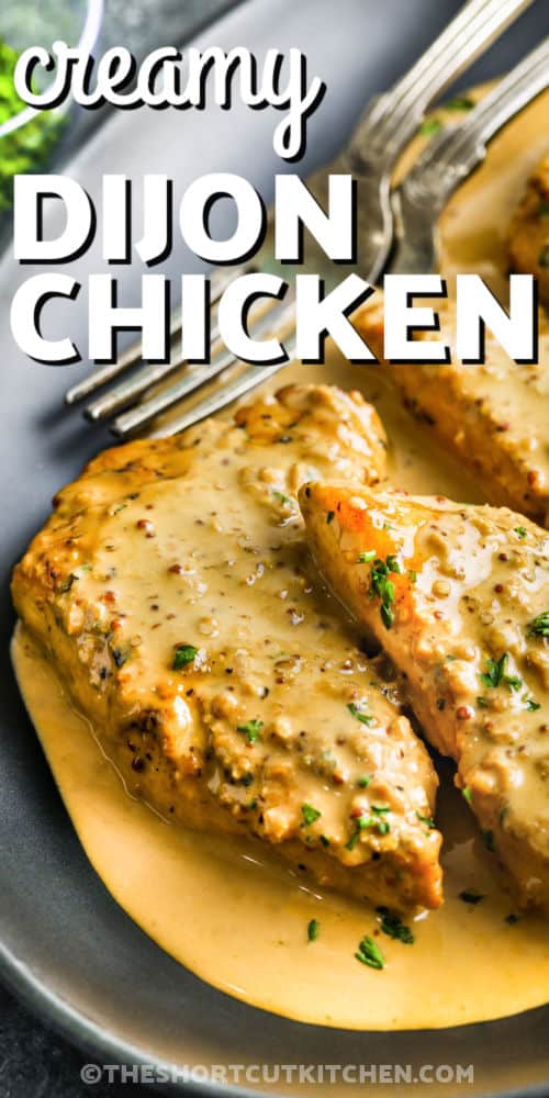 Creamy dijon chicken is the perfect recipe for a quick and easy dinner. Juicy chicken breasts are seared to perfection and then coated in a rich, creamy sauce made with Dijon mustard, soy sauce, and a splash of white wine. This skillet dish comes together fast, making it great for busy nights. Serve it over pasta or rice for a tender and flavorful meal everyone will love. #theshortcutkitchen Creamy Dijon Chicken on a plate with a fork and a title
