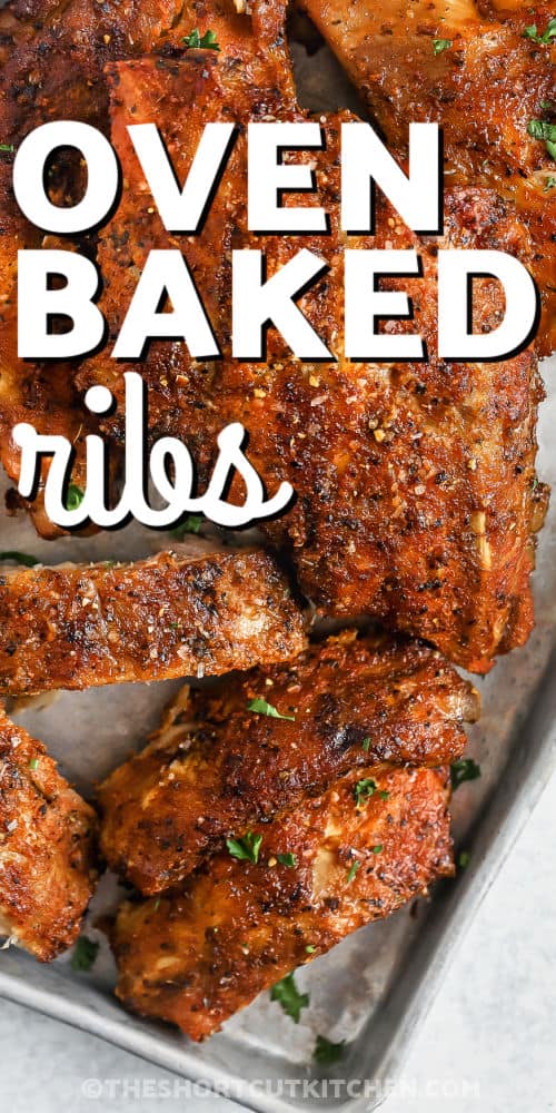 juicy and tender Oven Baked Ribs Recipe on a sheet pan with a title