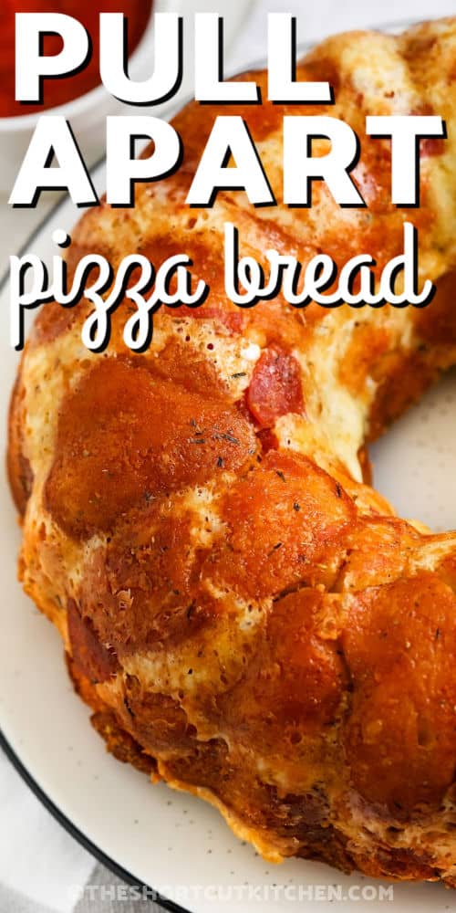 close up of Pull Apart Pizza Bread on a plate with a title