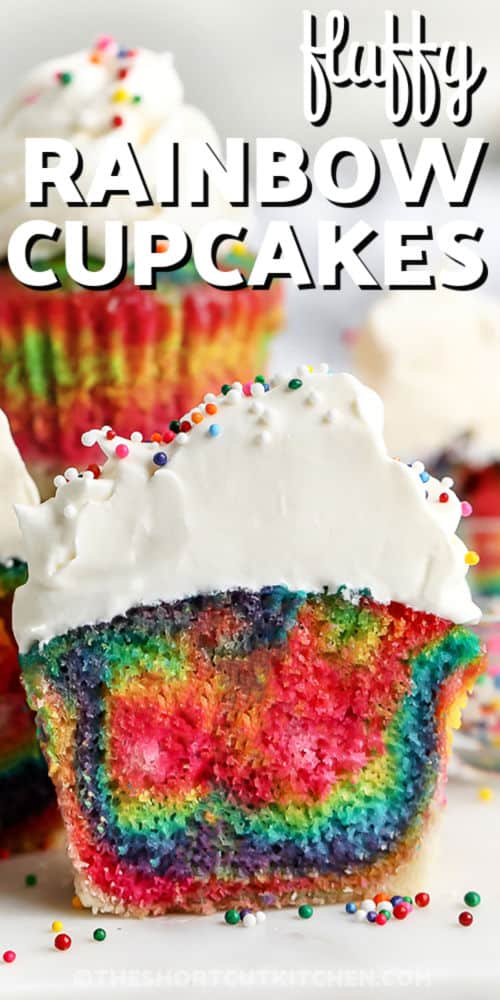 close up of fluffy Rainbow Cupcakes with writing