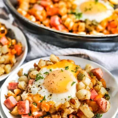 Breakfast Hash Recipe on a plate with pan full in the back