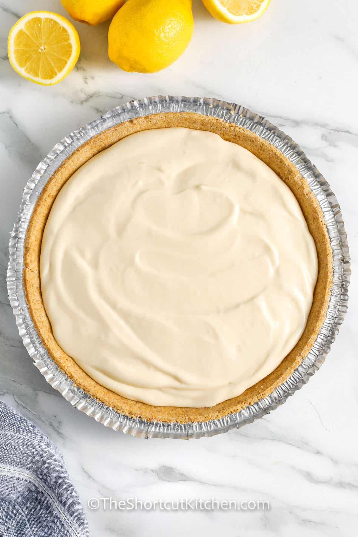 adding Creamy Lemon Pie Recipe filling to graham shell crust