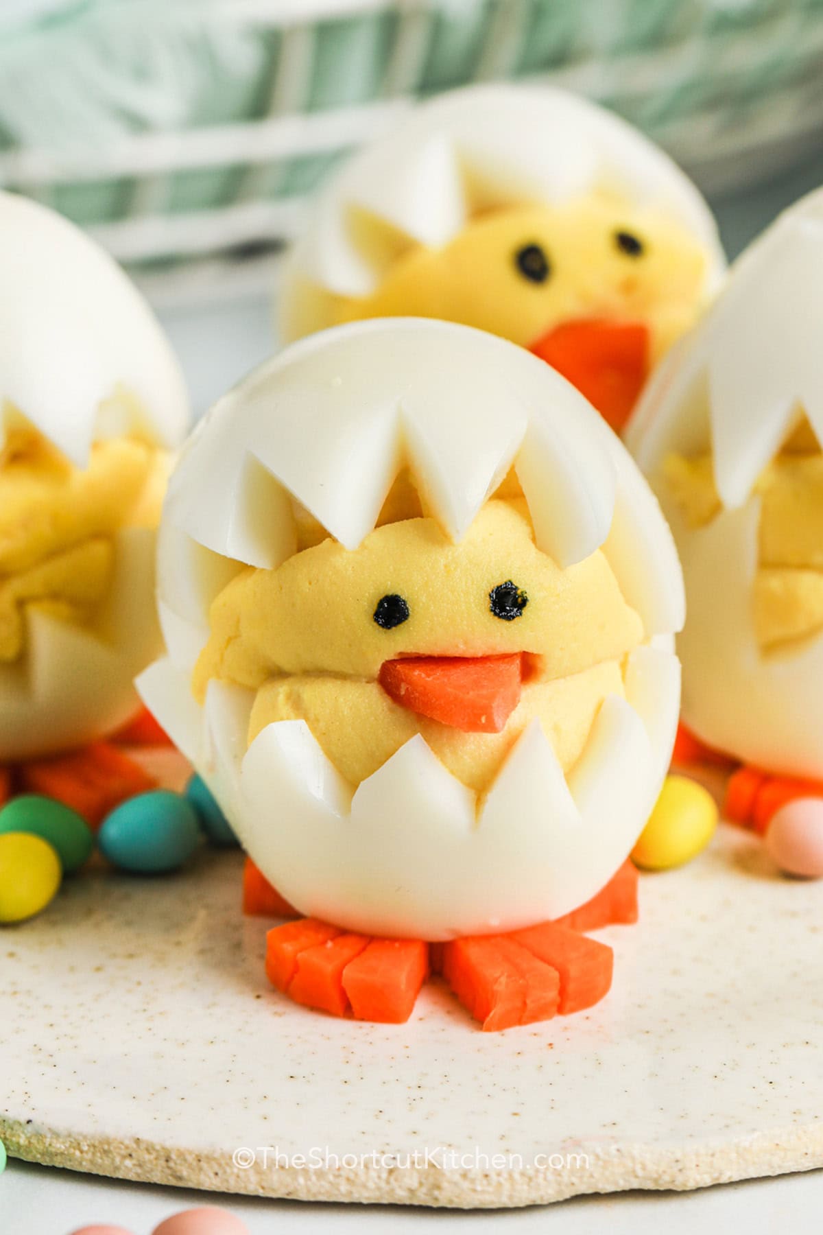 Deviled egg chicks make Easter brunch extra special with their cute and festive baby chick design! Made from hard-boiled eggs and filled with a creamy yolk mixture, they’re an easy, kid-friendly appetizer perfect for spring. Their adorable look makes them almost too cute to eat, but their delicious flavor will have everyone reaching for more. Plus, they’re a simple make-ahead recipe that keeps holiday prep stress-free. Bring some fun to your table! #theshortcutkitchen cropped Deviled Egg Chicks