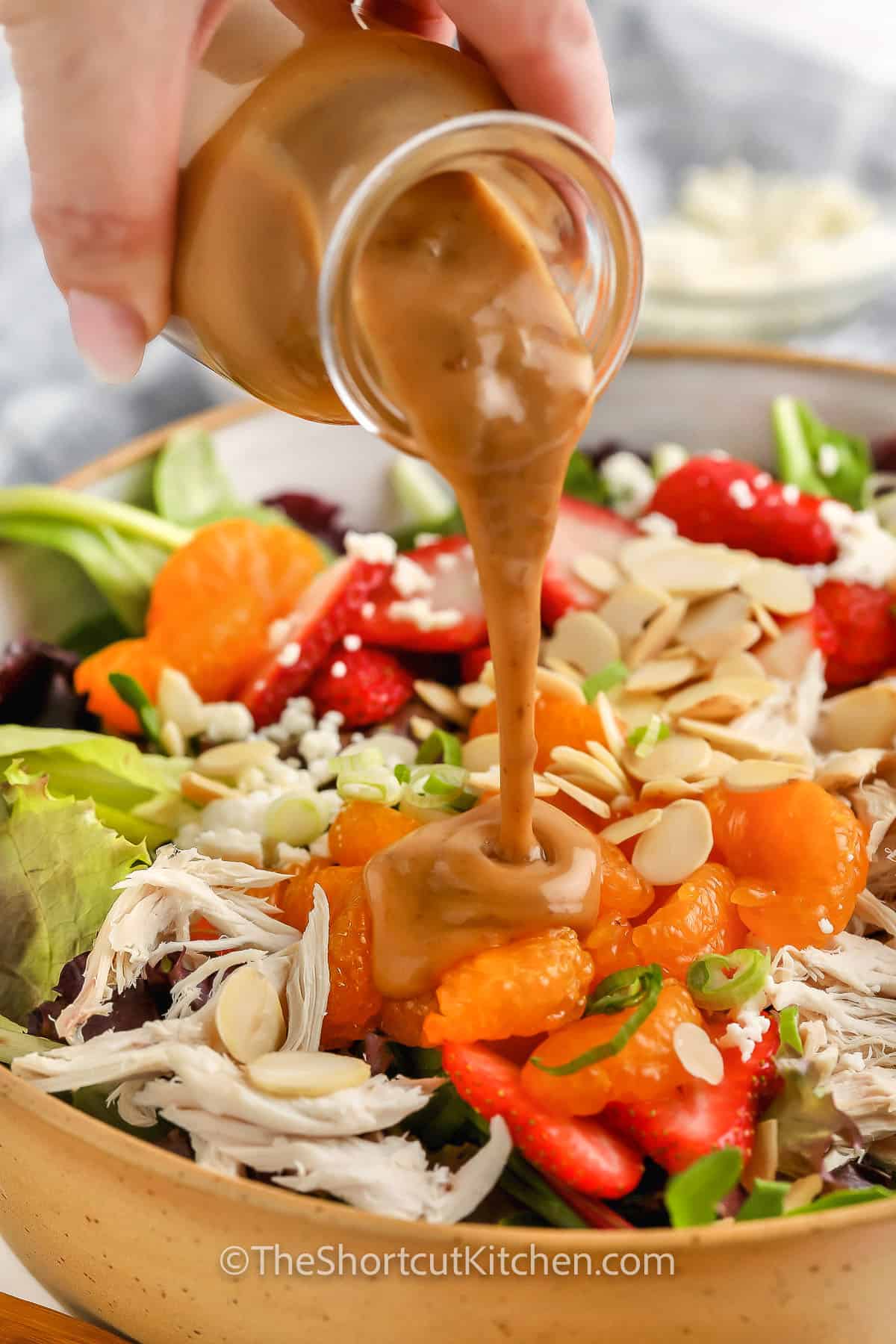 adding dressing to Easy Mandarin Chicken Salad Recipe