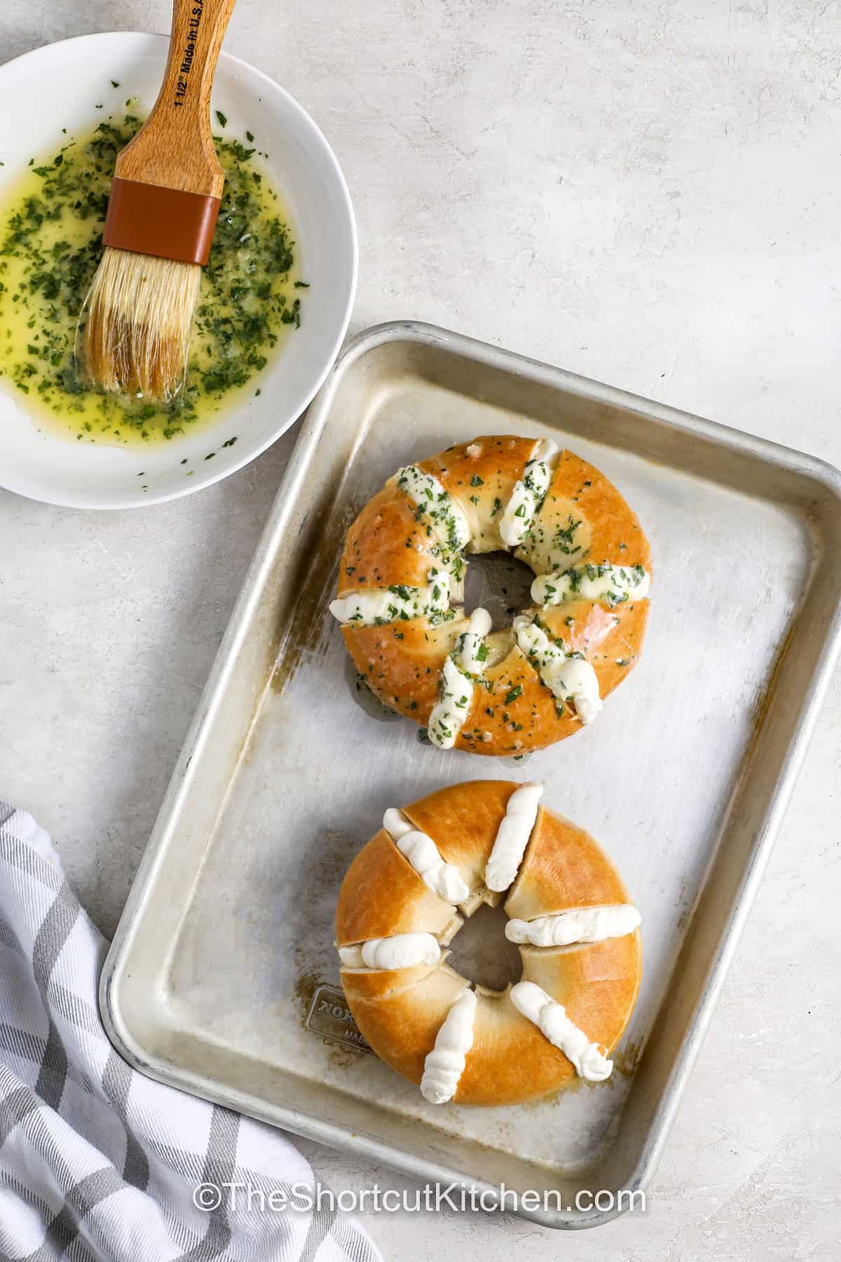 brushing butter and seasonings on Stuffed Bagels