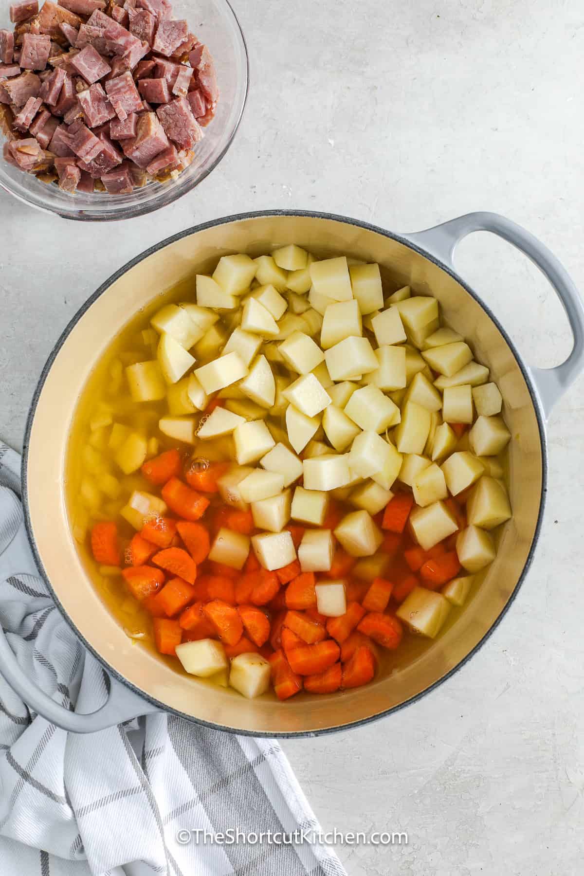 potatoes and carrots added to pot
