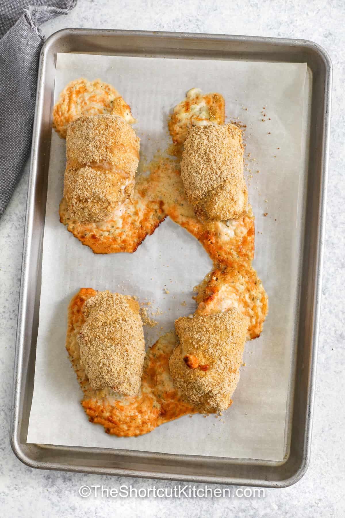 cheesy stuffed Chicken Rolls on a sheet pan