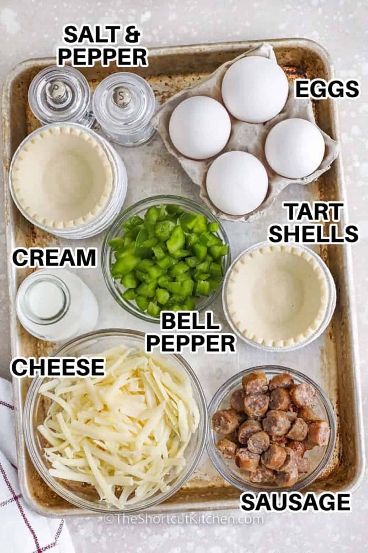 eggs , tart shells , bell pepper , sausage , cream , cheese , salt and pepper with labels to make Mini Quiches