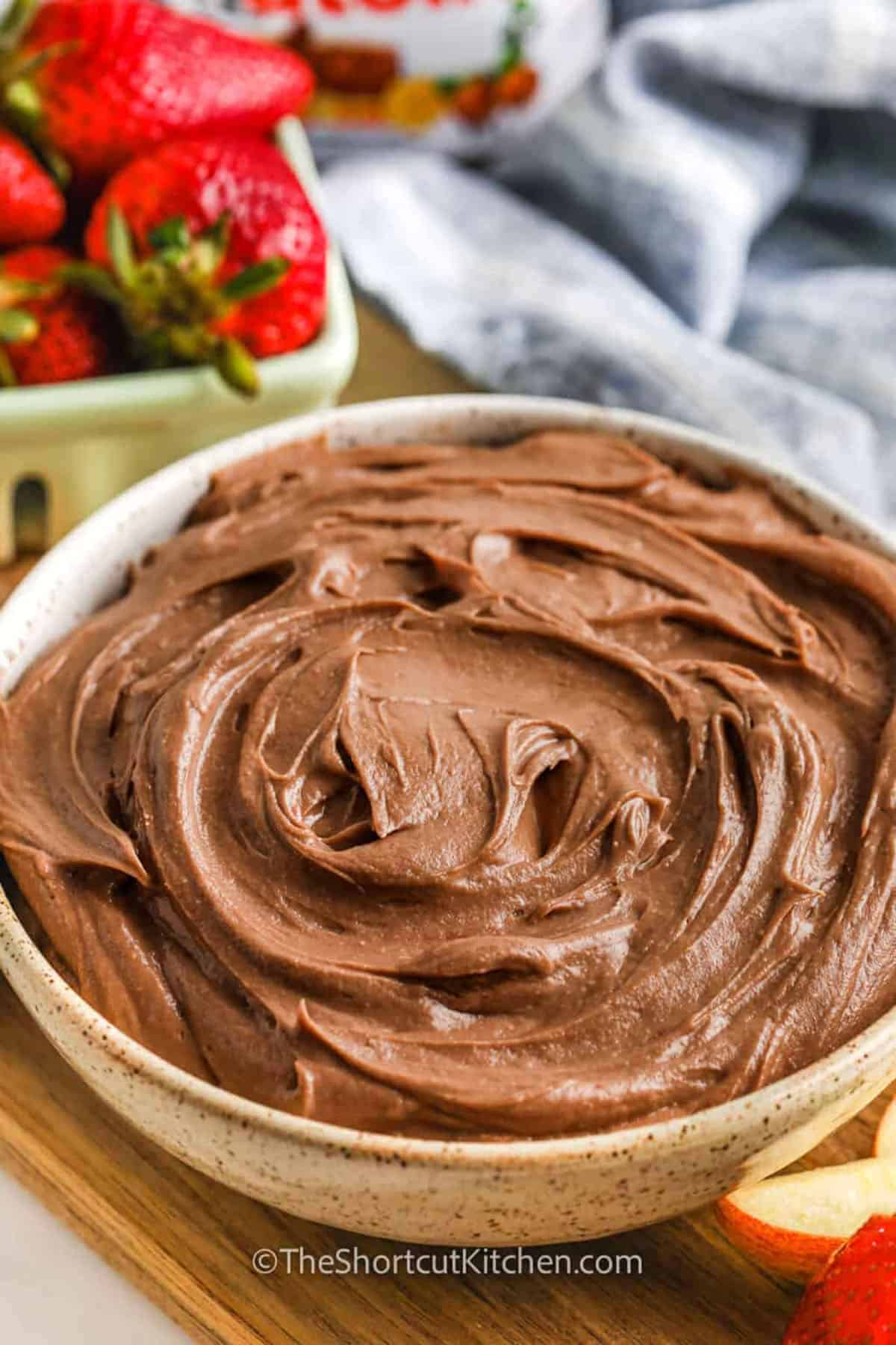 Fluffy Nutella dip is a kid friendly, no bake dessert topping or fruit dip that’s perfect for parties. It’s made with whipped cream cheese, chocolatey Nutella, and a bit of sugar for extra sweetness. This easy dip is great with cookies, pretzels, or crackers. Creamy and quick to make, it’s the kind of treat that disappears fast. Serve it anytime you want a little chocolate fun without turning on the oven. #theshortcutkitchen plated Nutella Dip