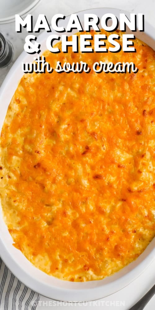 A casserole dish of macaroni and cheese with sour cream with a title