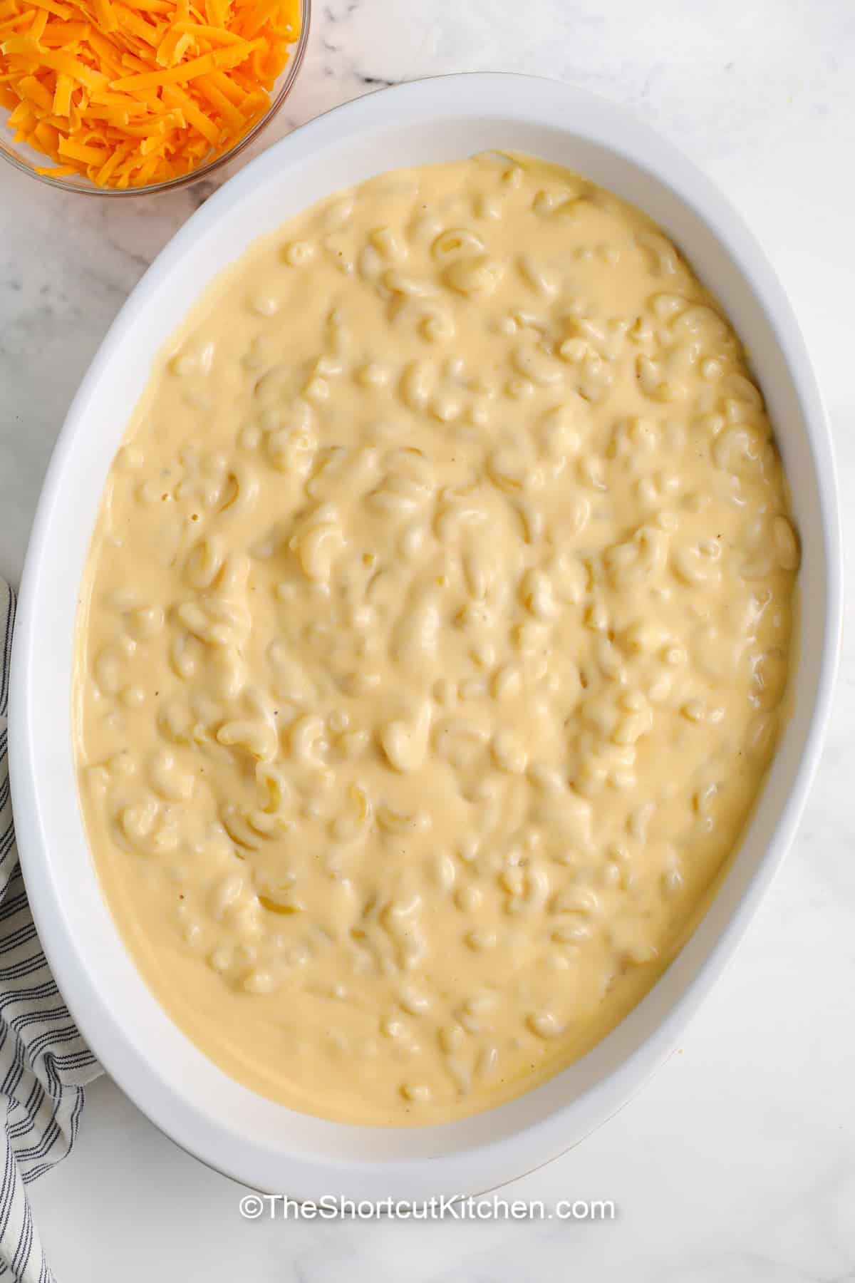 sour cream macaroni and cheese assembled in a casserole dish