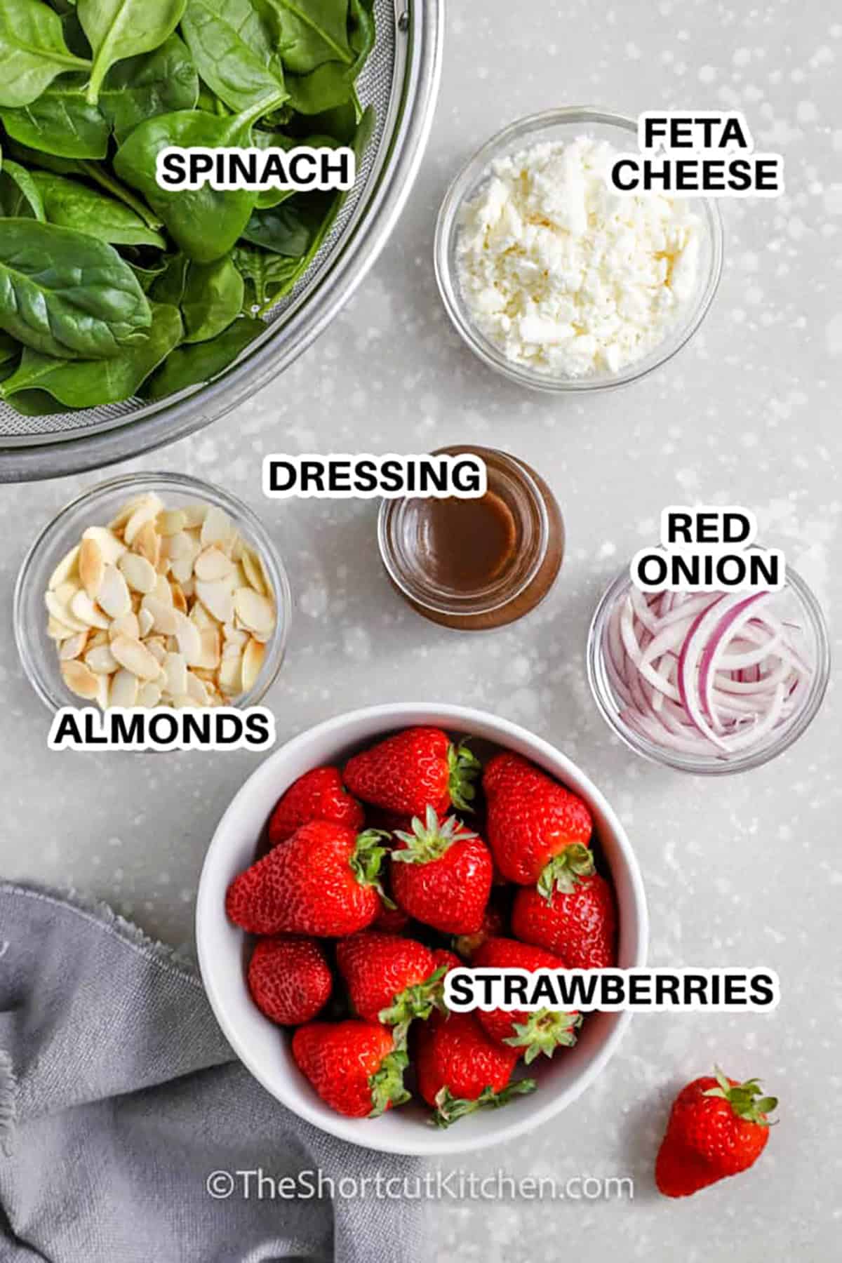 spinach , dressing , feta cheese , almonds , red onion , strawberries with labels to make Spinach and Strawberry Salad
