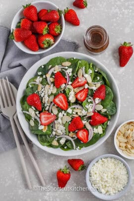 plated Spinach and Strawberry Salad with almonds onions and feta