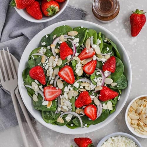 plated Spinach and Strawberry Salad with almonds onions and feta