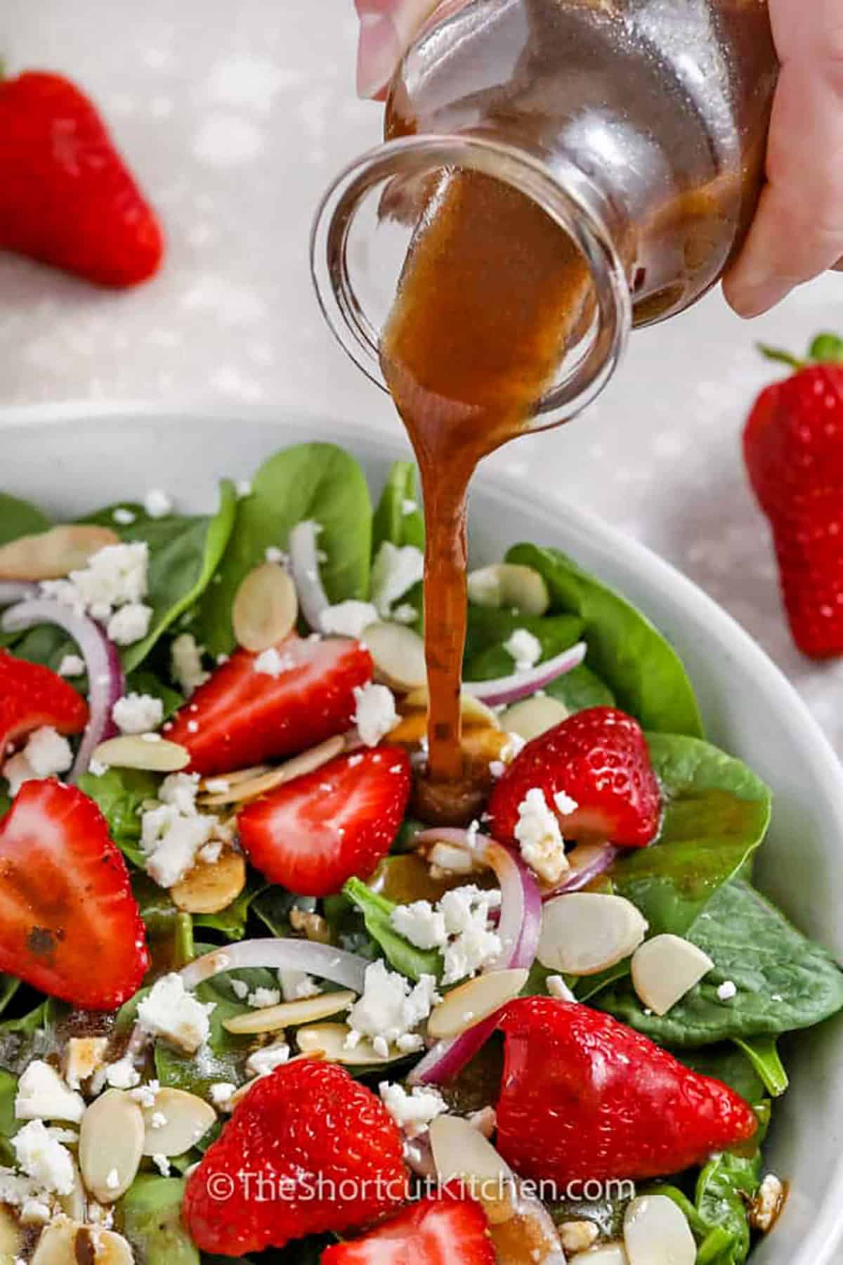 adding dressing to Spinach and Strawberry Salad