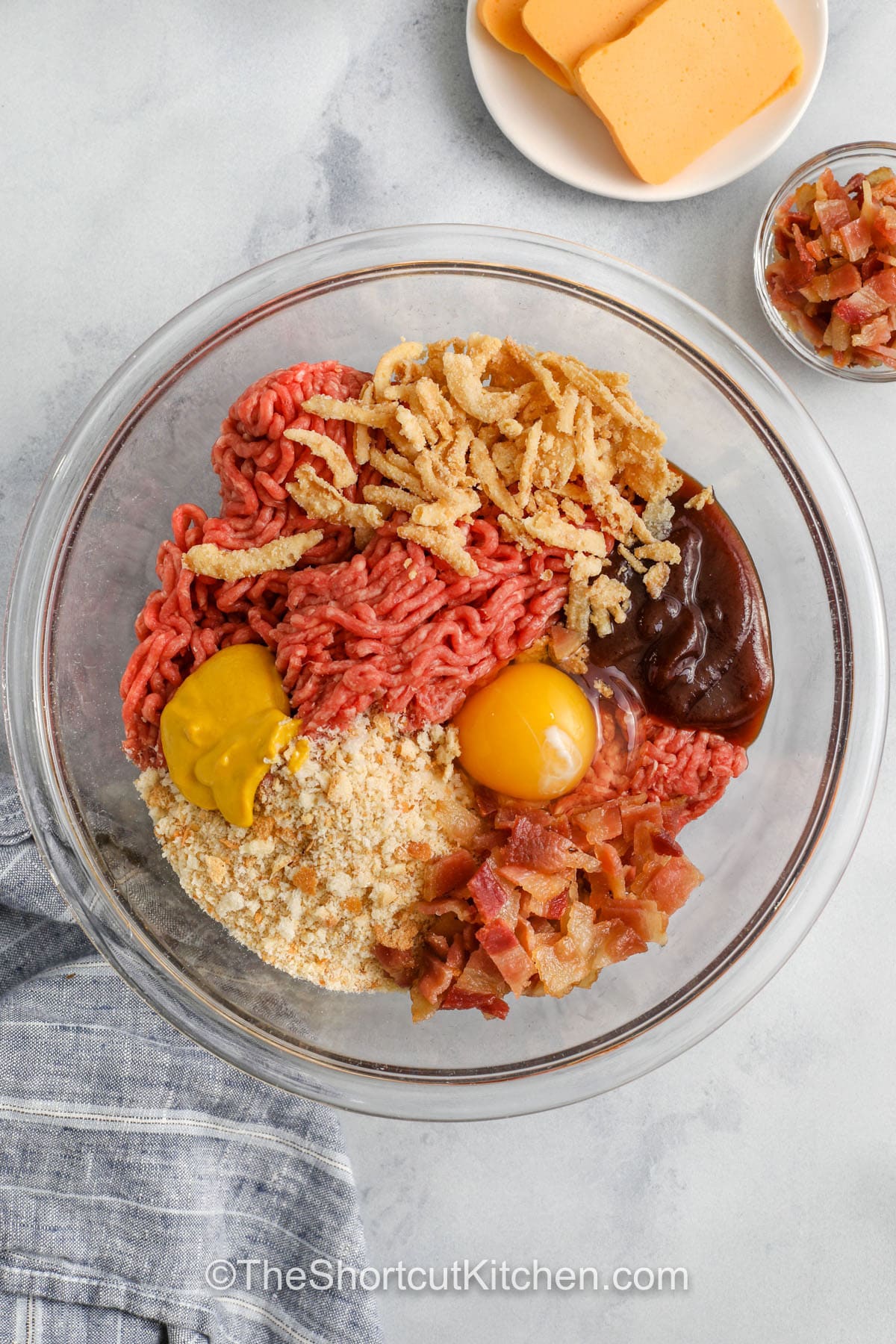 cheeseburger meatloaf ingredients in a mixing bowl