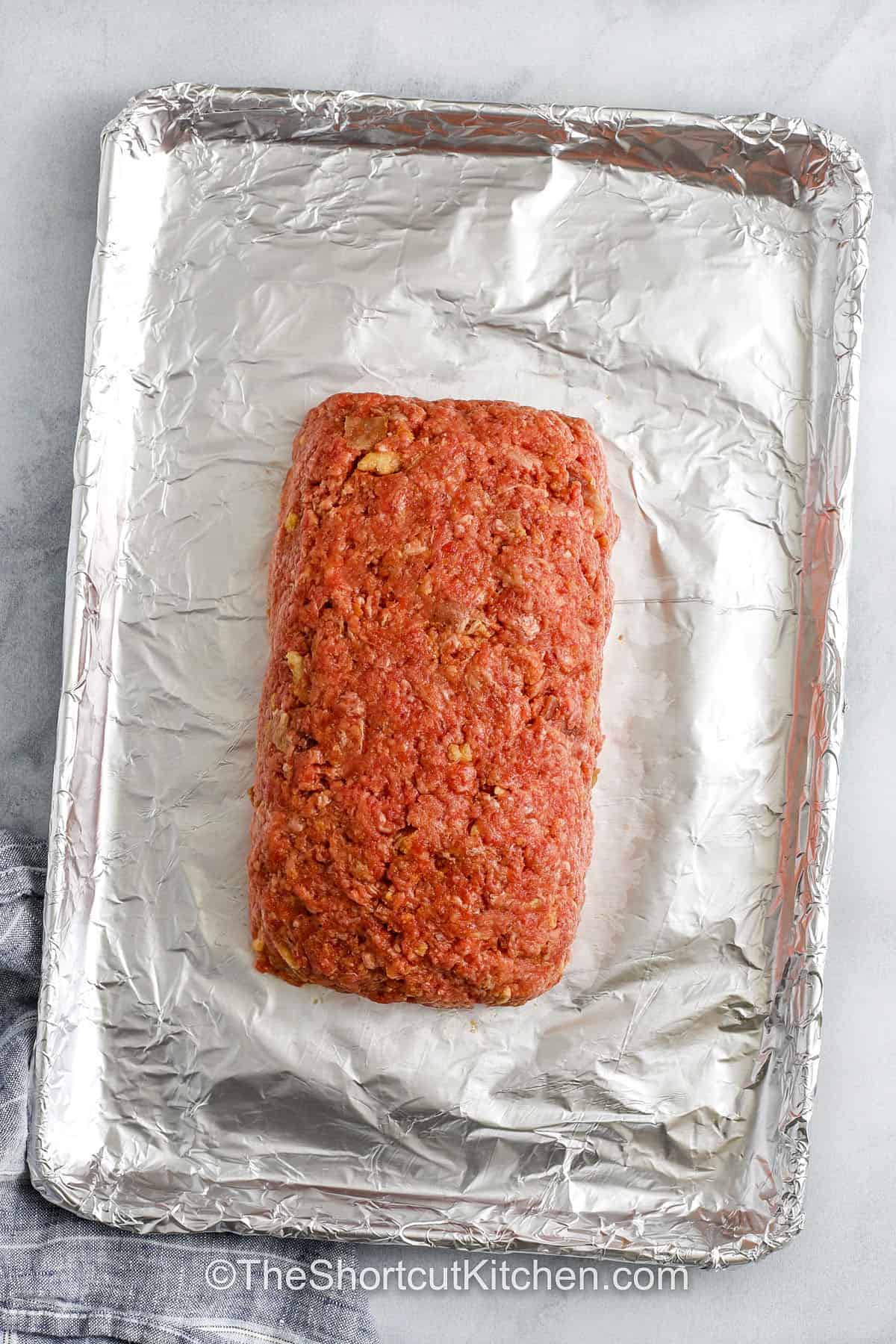 Bacon Cheeseburger Meatloaf on a sheet pan before cooking