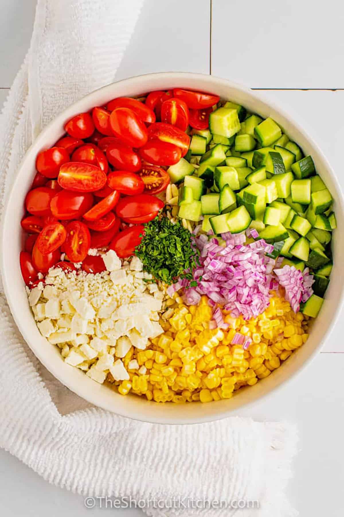 ingredients in a bowl to make Orzo Pasta Salad Recipe