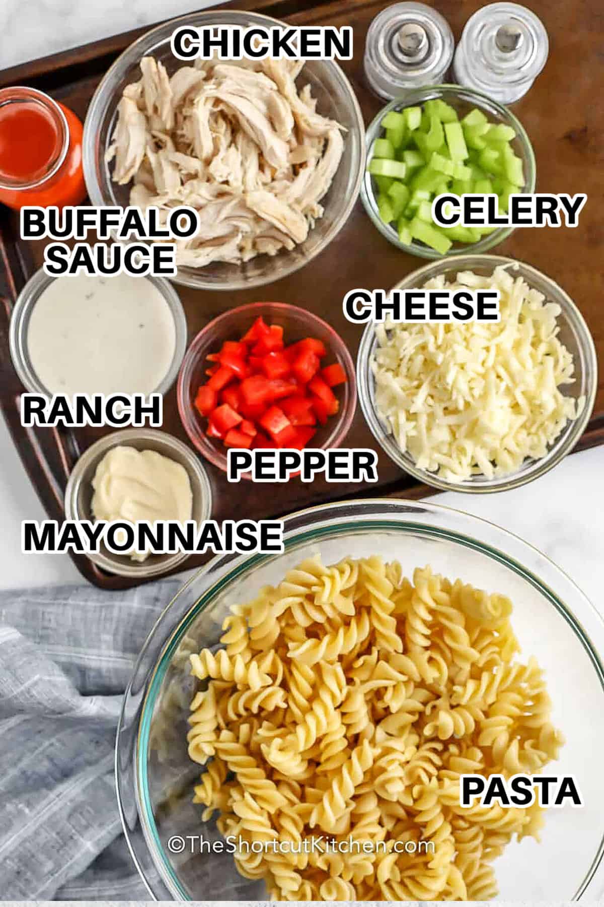 buffalo sauce , chicken , ranch , celery , pepper , cheese and pasta with labels to make Buffalo Chicken and Pasta Salad