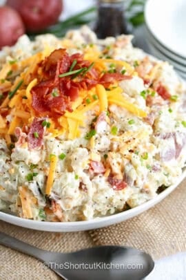 bowl of Loaded Potato Salad Recipe with crispy bacon and cheese on top