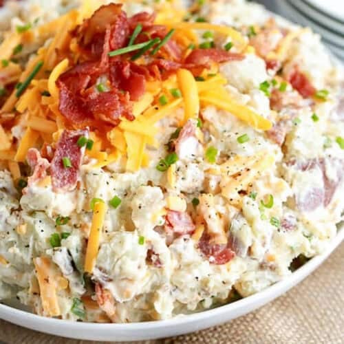 bowl of Loaded Potato Salad Recipe with crispy bacon and cheese on top