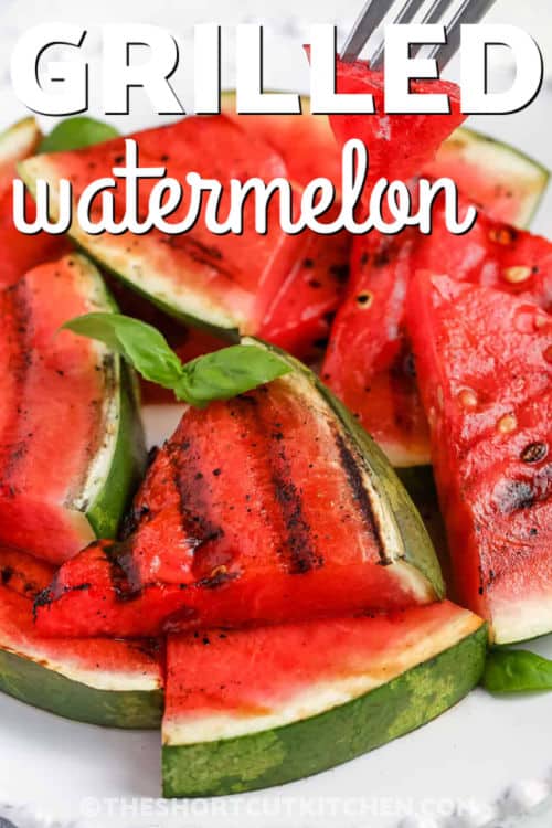 Grilled watermelon brings out the best of sweet and savory in one quick and easy dish. Thick slices of watermelon are brushed with balsamic vinaigrette and then grilled to perfection in just minutes. The result is lightly charred fruit with juicy centers and a rich, tangy flavor. It’s a perfect side for grilled meats or a fun starter that’s always a conversation piece! #theshortcutkitchen juicy Grilled Watermelon on a plate with writing