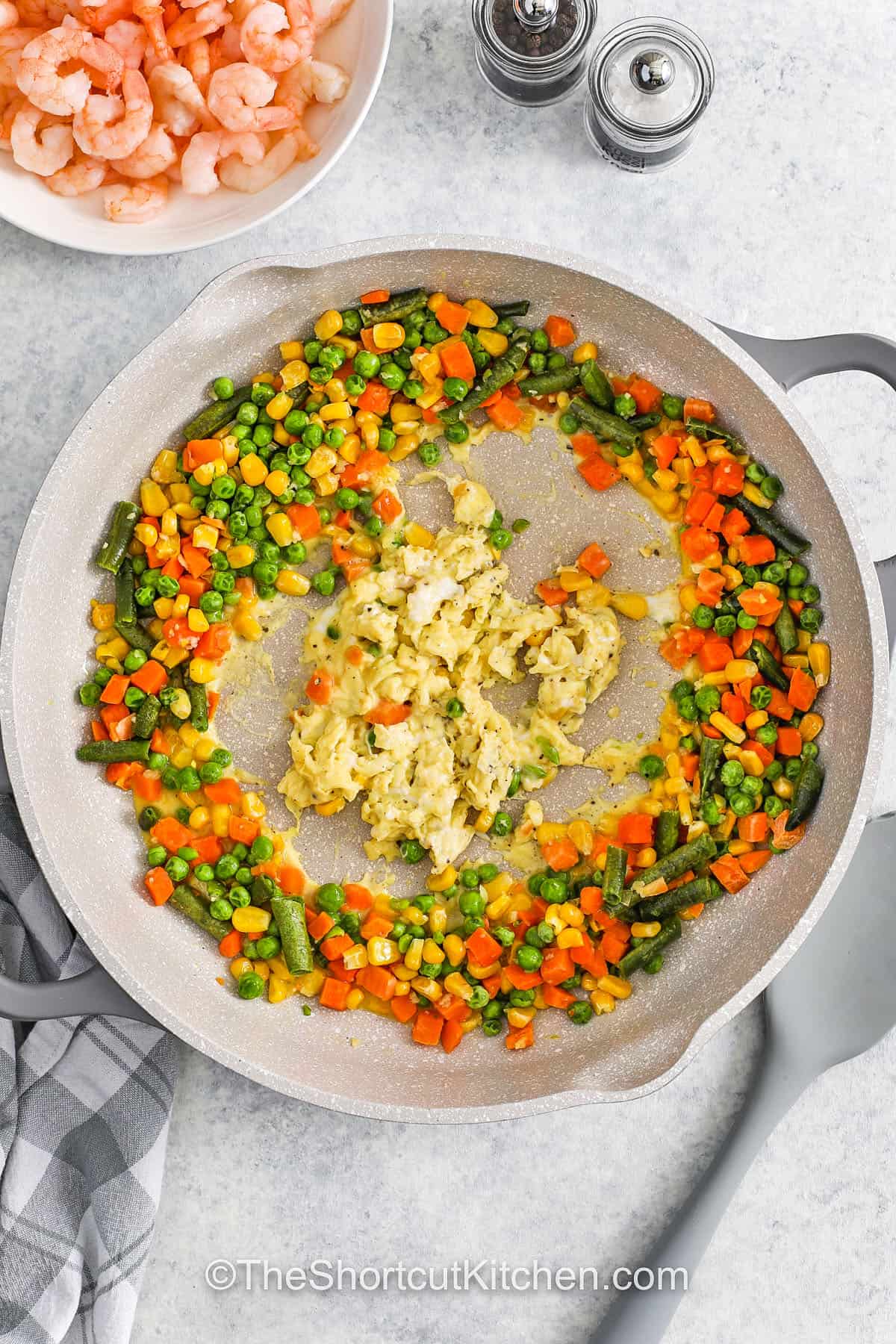 cooking vegetables in a pan to make Shrimp Fried Rice