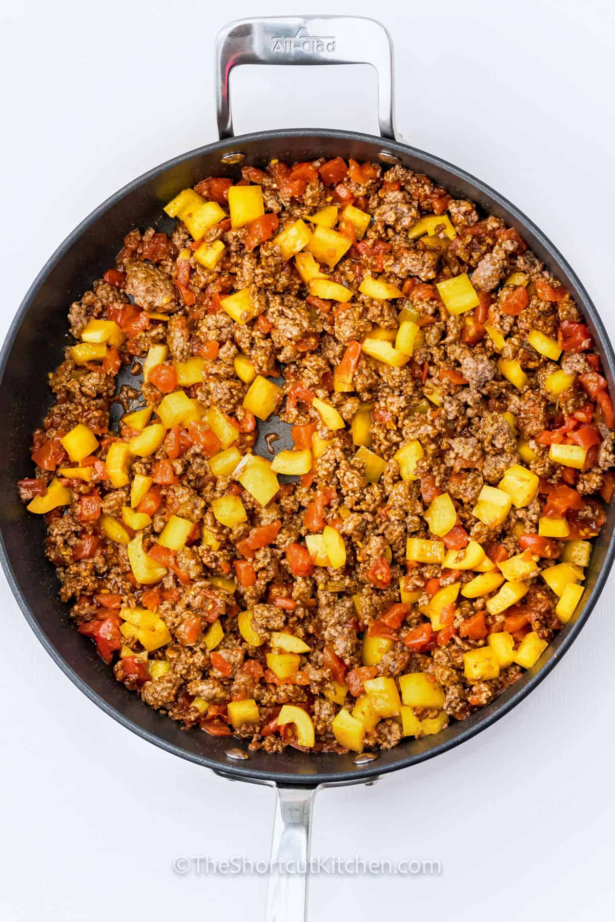 cooking beef with vegetables to make Taco Spaghetti Recipe