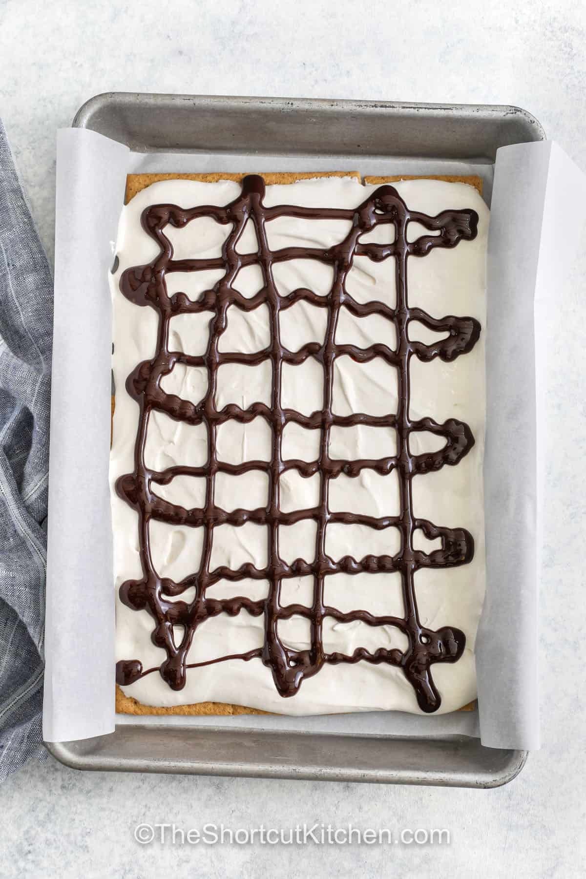 s'more in a pan drizzled with chocolate