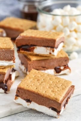 cut s'mores on a cutting board with marshmallows