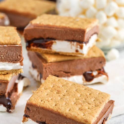 cut s'mores on a cutting board with marshmallows